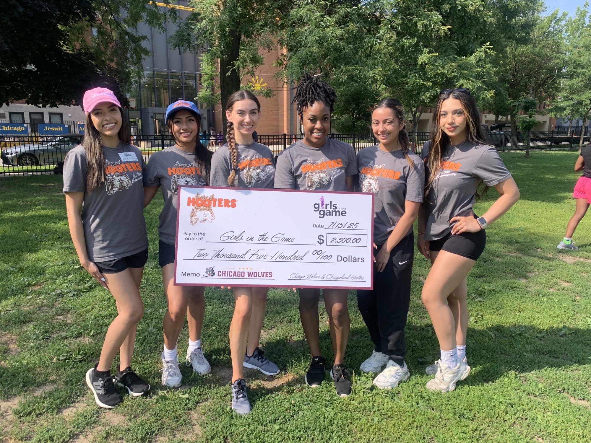 Hooters $2500 donation to Girls in the Game, Chicago Wolves "Score for Charity"